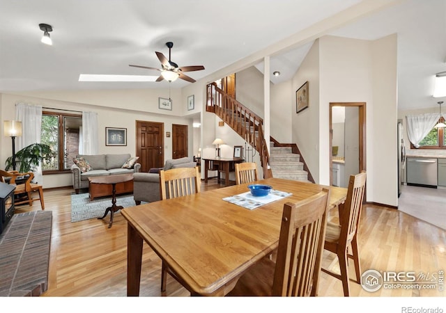 dining space with stairway, a healthy amount of sunlight, and light wood-style floors