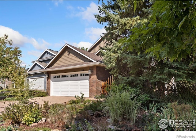 view of front of property featuring brick siding, an attached garage, and driveway