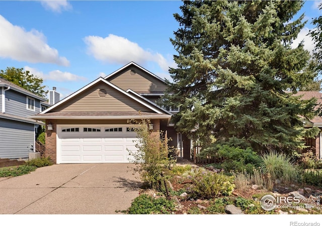 view of front of property featuring brick siding, an attached garage, and concrete driveway