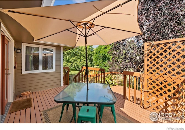 wooden terrace featuring outdoor dining area