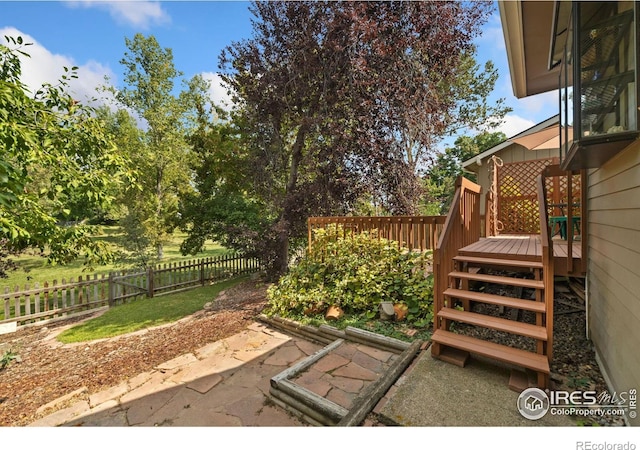 view of patio / terrace with a deck and fence private yard