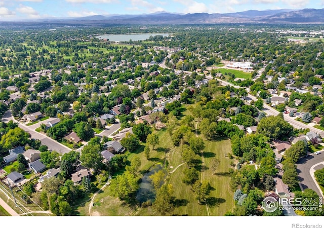 drone / aerial view featuring a water and mountain view