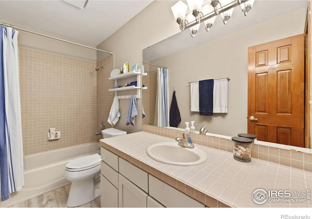 full bathroom featuring shower / bath combo with shower curtain, toilet, vanity, and wood finished floors