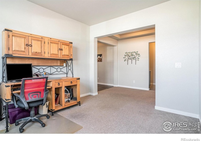 carpeted home office featuring baseboards