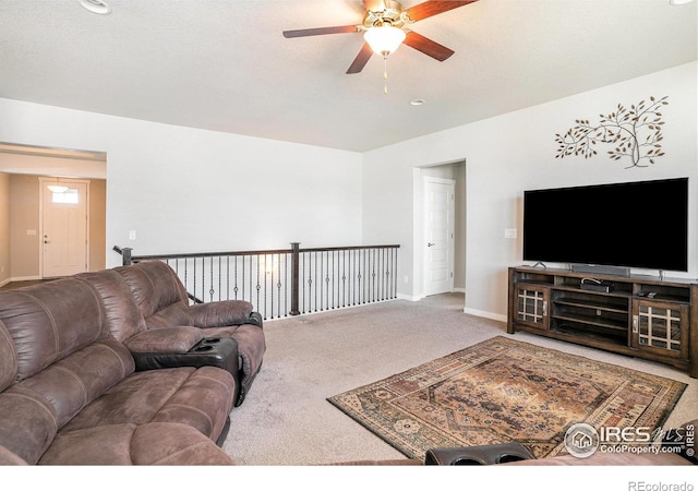 living room featuring baseboards, ceiling fan, and carpet flooring