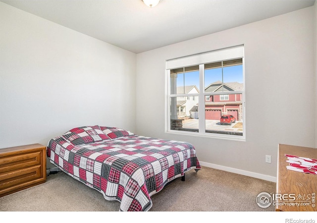 bedroom featuring baseboards and carpet