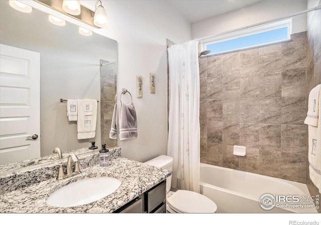 full bathroom with vanity, shower / bath combination with curtain, and toilet