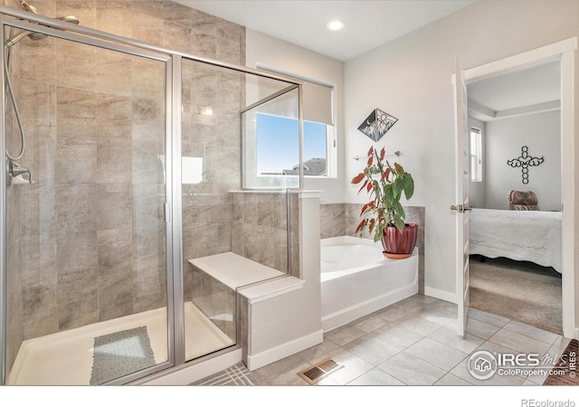 bathroom with tile patterned floors, plenty of natural light, and a stall shower