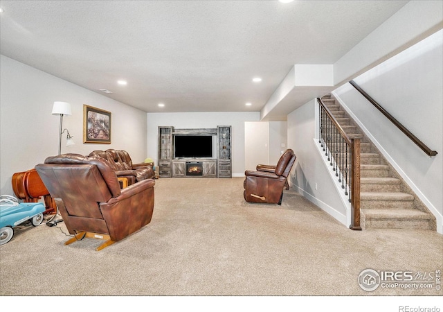 carpeted living room with recessed lighting, a textured ceiling, stairs, and baseboards