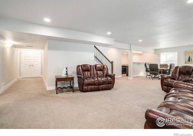 carpeted living area featuring recessed lighting, visible vents, baseboards, and a textured ceiling