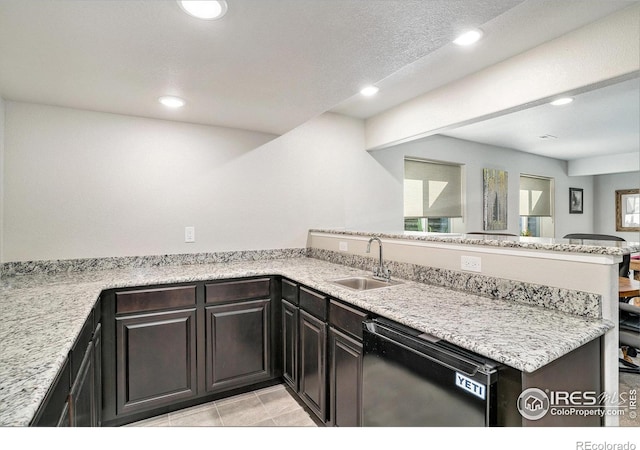 kitchen with recessed lighting, dishwasher, a peninsula, and a sink