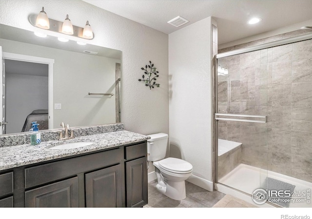 ensuite bathroom with visible vents, toilet, a stall shower, connected bathroom, and vanity