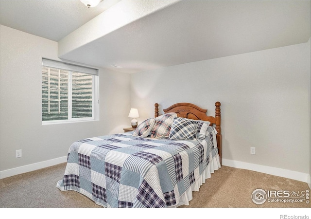 bedroom featuring carpet and baseboards