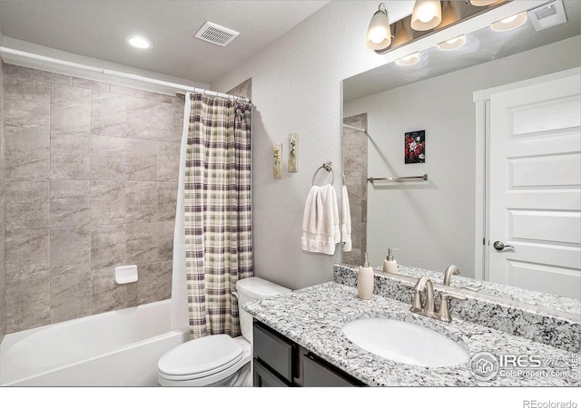 bathroom featuring visible vents, toilet, shower / bath combo, vanity, and a textured wall