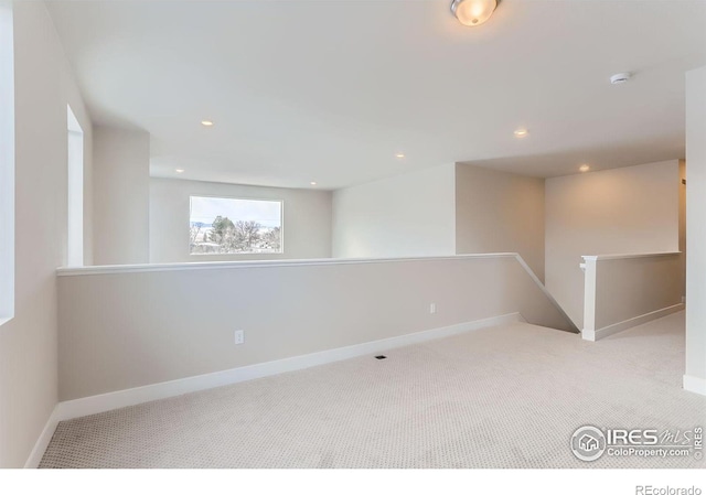 spare room with recessed lighting, baseboards, and carpet