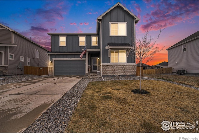 traditional home featuring cooling unit, board and batten siding, an attached garage, and fence