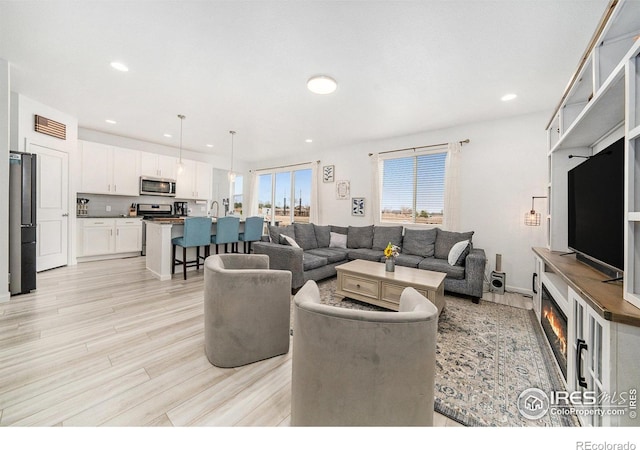 living room featuring recessed lighting and light wood-type flooring