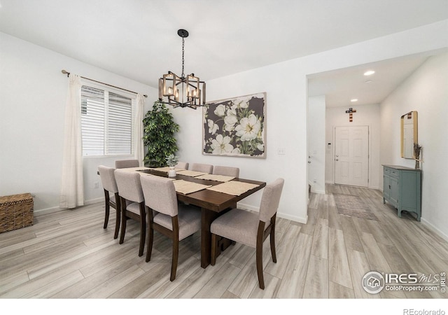 dining room featuring recessed lighting, light wood-type flooring, baseboards, and a notable chandelier