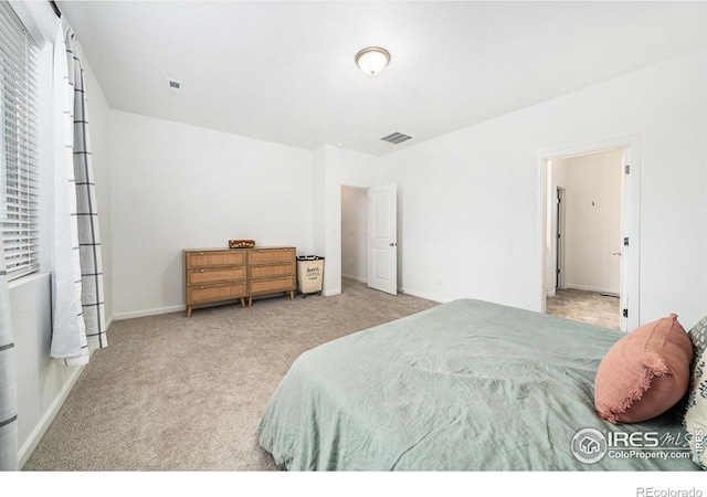 carpeted bedroom with visible vents and baseboards