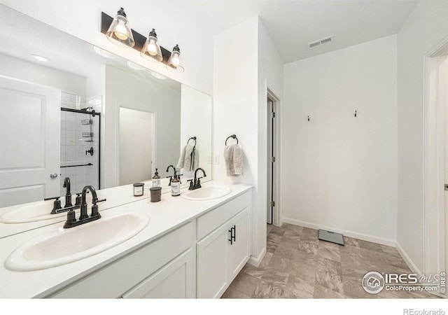 bathroom featuring a sink, visible vents, double vanity, and a shower stall