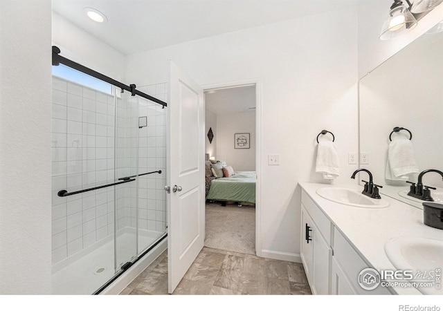 bathroom featuring a sink, connected bathroom, double vanity, and a shower stall