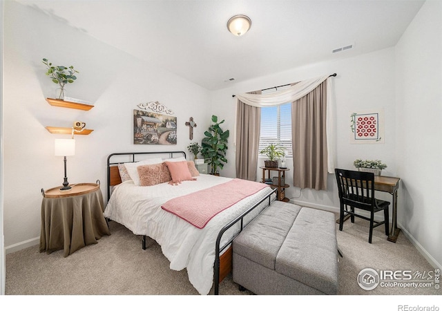 carpeted bedroom featuring visible vents and baseboards