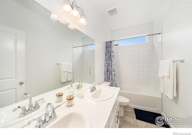 full bath with double vanity, visible vents, toilet, and a sink