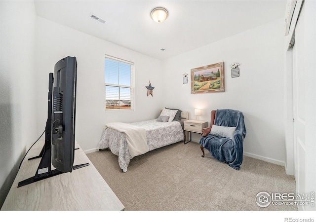 carpeted bedroom featuring baseboards and visible vents