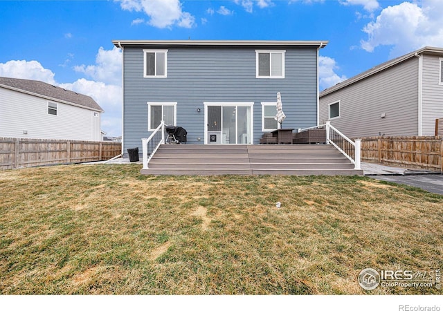 rear view of property with a yard, a wooden deck, and a fenced backyard