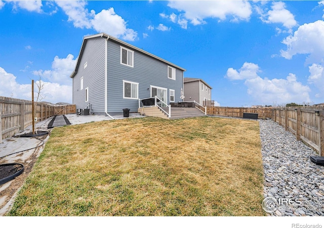 back of property featuring a lawn, a deck, a fenced backyard, cooling unit, and a patio area