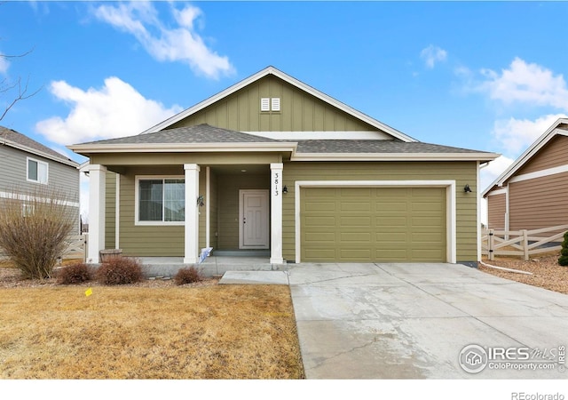 view of front of home with fence, an attached garage, covered porch, concrete driveway, and board and batten siding