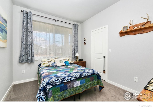 carpeted bedroom featuring baseboards