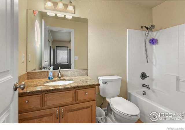 bathroom featuring toilet, vanity, and shower / bath combination