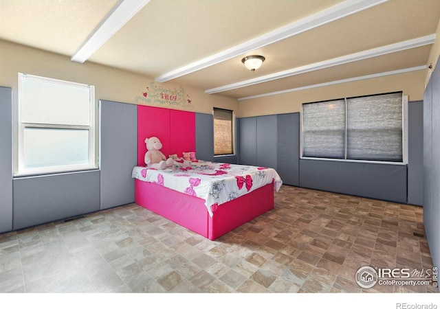 bedroom featuring beam ceiling