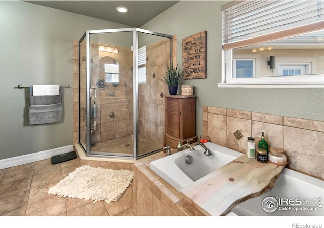 full bathroom featuring tile patterned floors, baseboards, a stall shower, and a garden tub