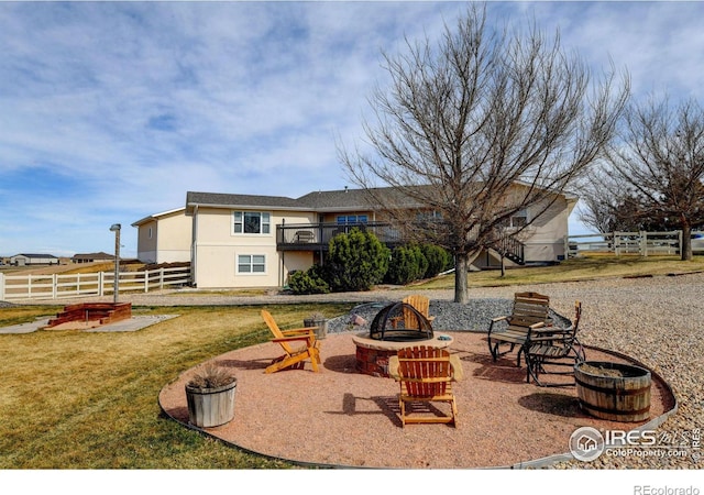 view of patio with fence and a fire pit