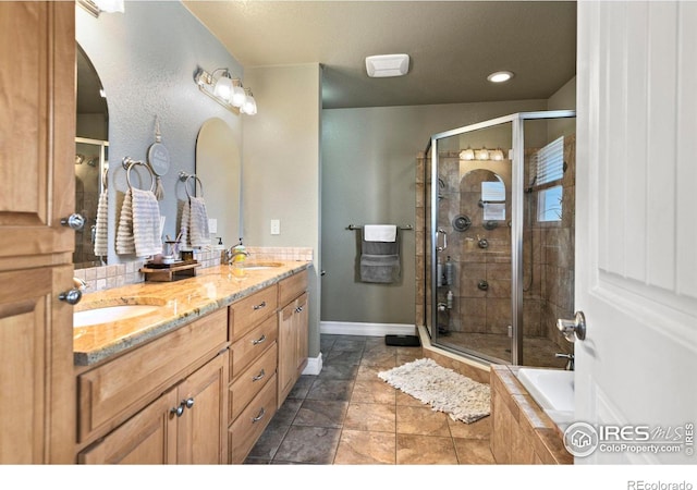 33409 Faith Ln, Eaton, CO 80615 - full bathroom with double vanity, a stall shower, and tiled bath