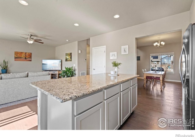 kitchen featuring freestanding refrigerator, dark wood-style flooring, ceiling fan, light stone countertops, and recessed lighting