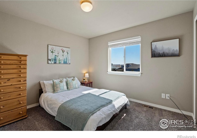 bedroom with carpet flooring and baseboards