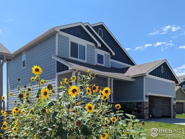 view of front of home with board and batten siding and roof with shingles