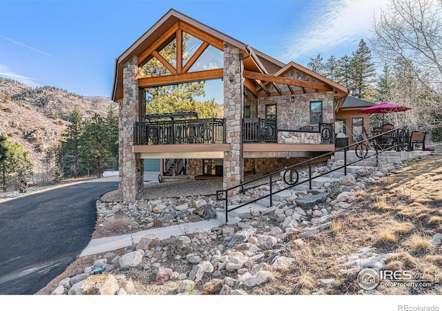 9512 County Road 43, Glen Haven, CO 80532 - rear view of property with stairs, stone siding, and a wooden deck