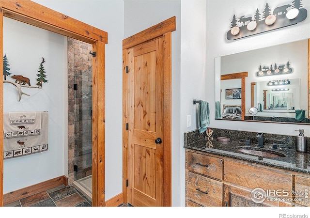 9512 County Road 43, Glen Haven, CO 80532 - full bathroom featuring baseboards, a stall shower, vanity, and stone finish floor