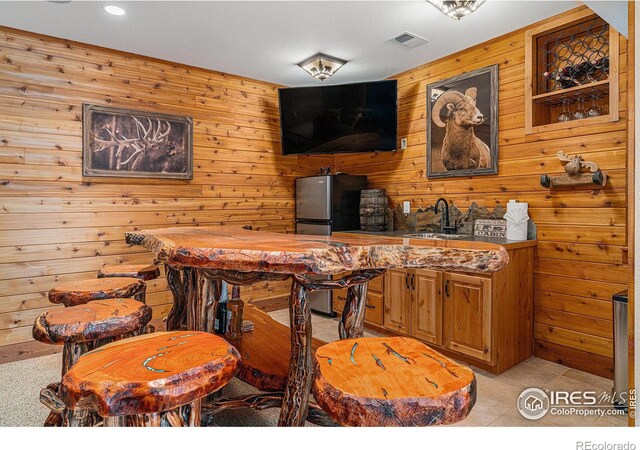 9512 County Road 43, Glen Haven, CO 80532 - bar with a sink, visible vents, and freestanding refrigerator
