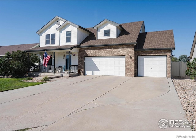 view of front of property featuring covered porch, concrete driveway, roof with shingles, a garage, and brick siding