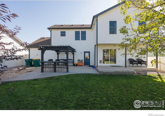 rear view of house featuring a patio area, fence, a yard, and a pergola