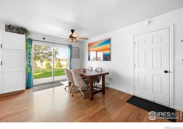 dining area featuring visible vents, baseboards, light wood finished floors, and ceiling fan