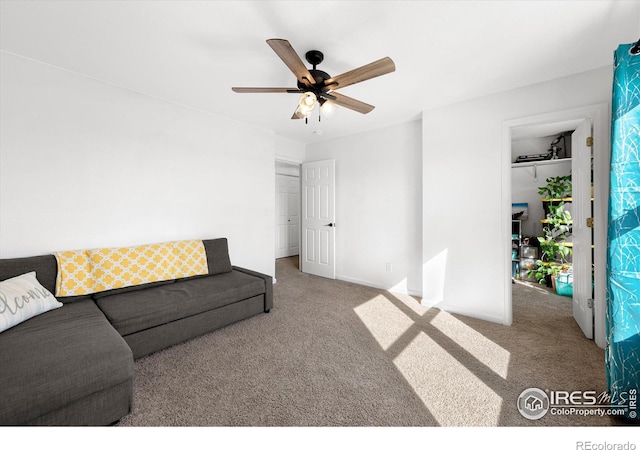 carpeted living room with baseboards and a ceiling fan