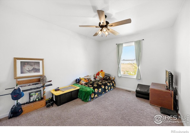 bedroom with carpet flooring, visible vents, baseboards, and a ceiling fan