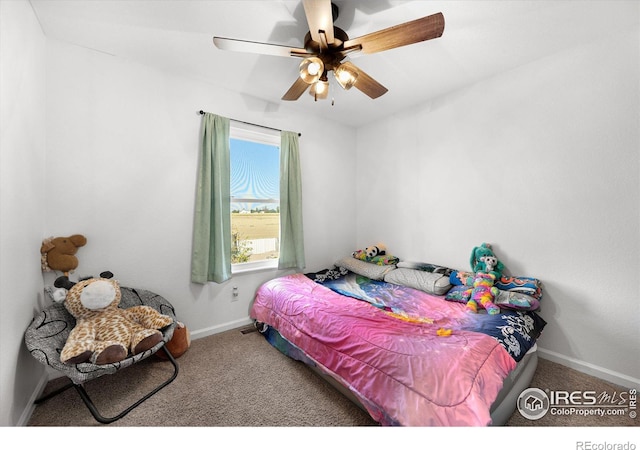 bedroom with baseboards, carpet floors, and a ceiling fan