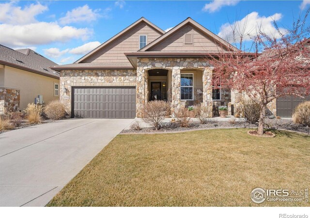 view of front of house with a front lawn, concrete driveway, a garage, and stone siding